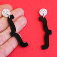 Curly bracket earrings in hand