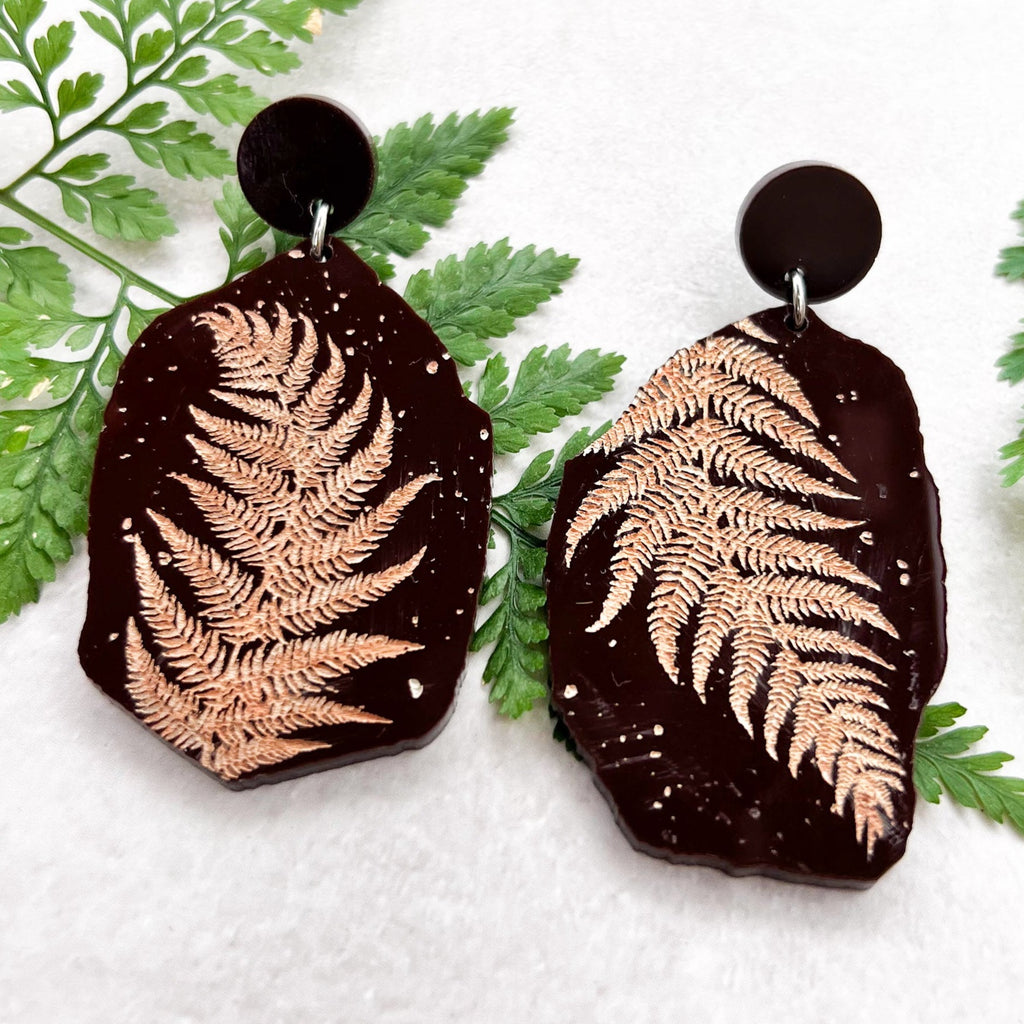 Acrylic fern fossil earrings, in brown acrylic, with beige handpainted fern imprints, made to look like real lifelike fossils.