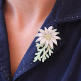 Acrylic flannel flower brooch being worn on a blue collar.