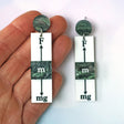 Pair of rectangular dangle earrings with scientific force diagram design on a white background