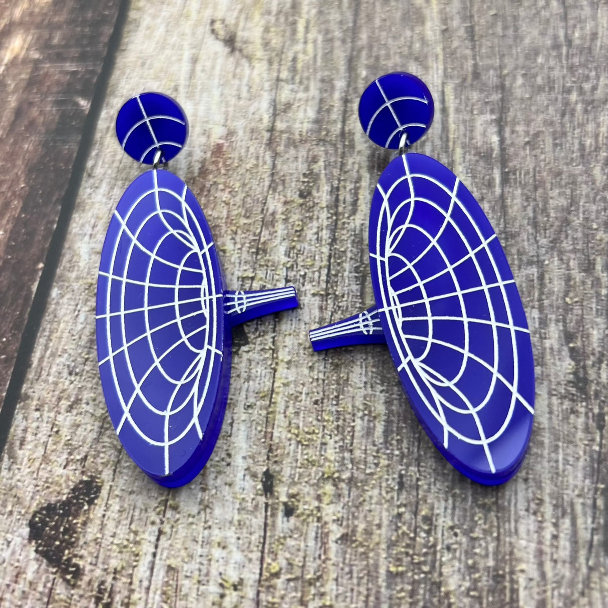 Dark blue dangle acrylic wormhole earrings, view 1.