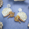 Laser cut acrylic hermit crab earrings, closeup. 