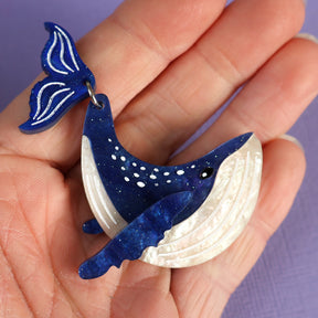 Acrylic Humpback whale brooch being held in a hand