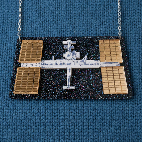 Statement acrylic necklace depicting the international space station, with stainless steel chain. 