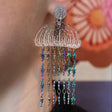 Glittery Acrylic jellyfish earrings with rainbow star chain, being modelled. 