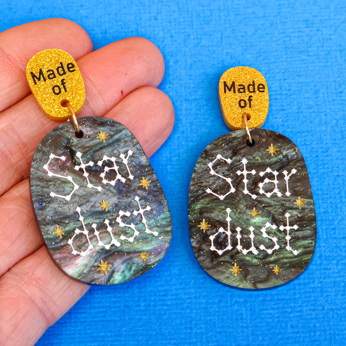 Made of Stardust earrings in hand
