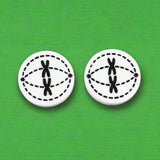 Pair of round black and white acrylic stud earrings with meiosis design.