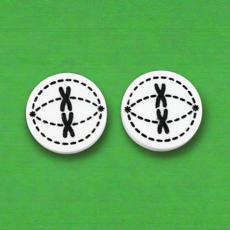 Pair of round black and white acrylic stud earrings with meiosis design.