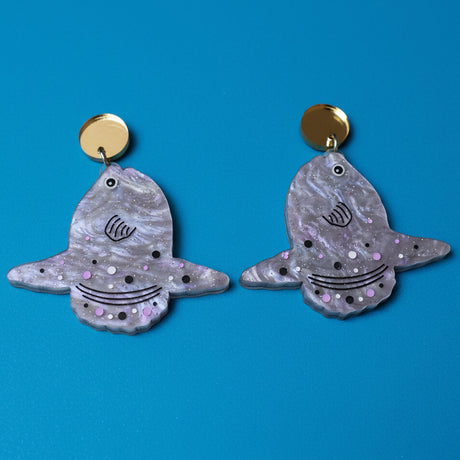 Pair of mola mola (sun fish) earrings with glittery finish and gold mirror acrylic toppers. 