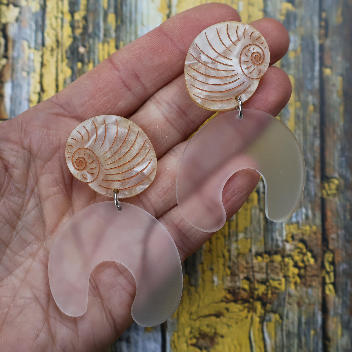 Moon snail shell and egg acrylic laser cut earrings. 