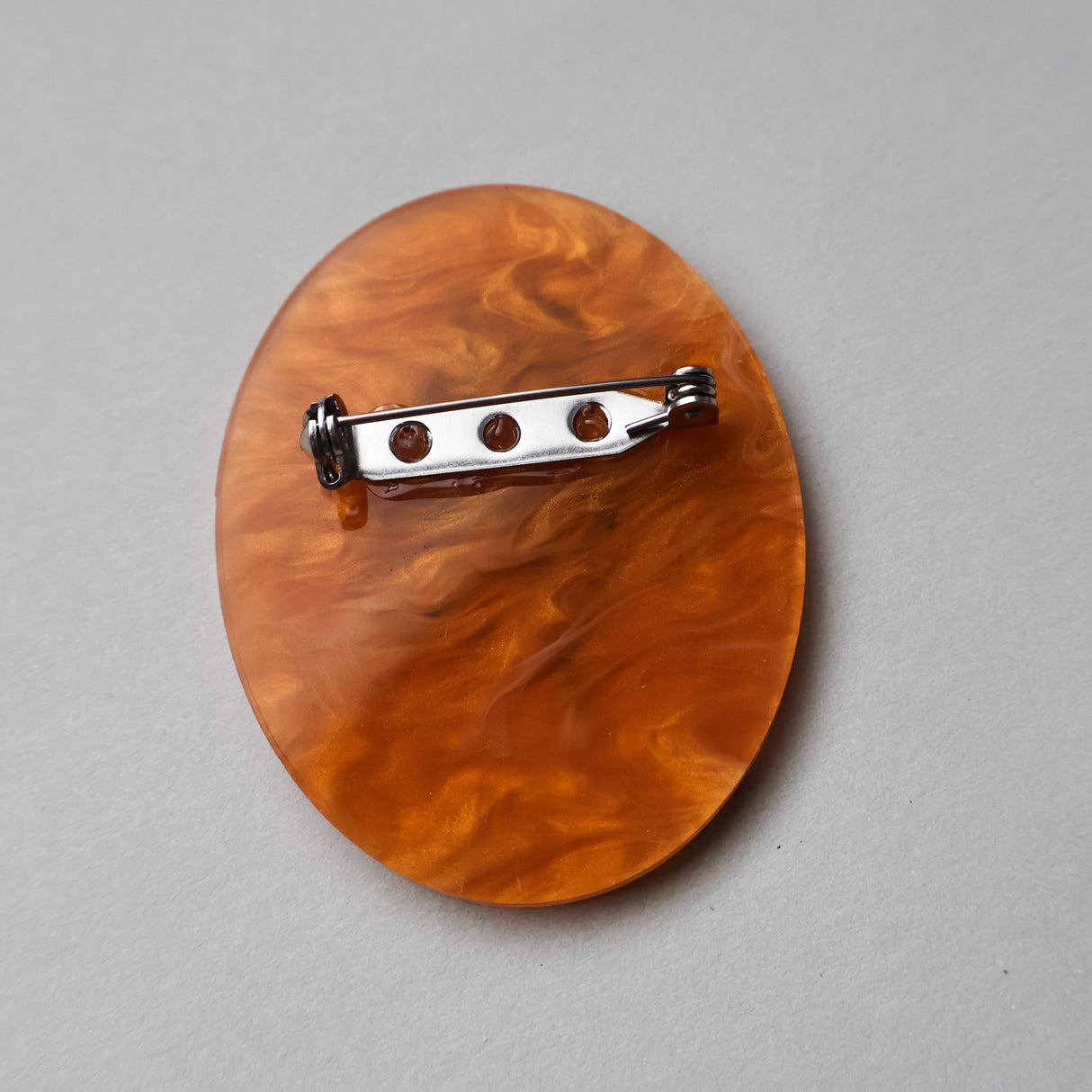 Back view of a Mosquito in amber acrylic brooch, showing stainless steel pin. 