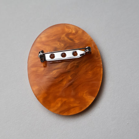 Back view of a Mosquito in amber acrylic brooch, showing stainless steel pin. 