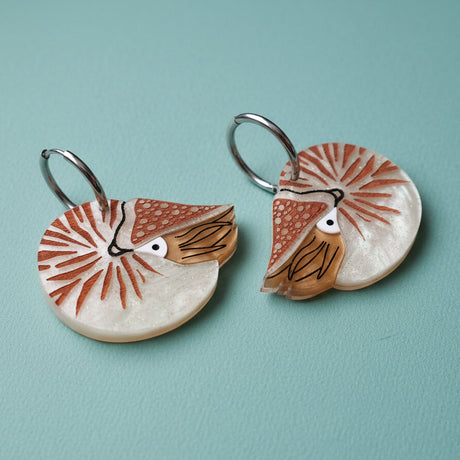Pair of acrylic  earrings with nautilus design with huggie hoops. 