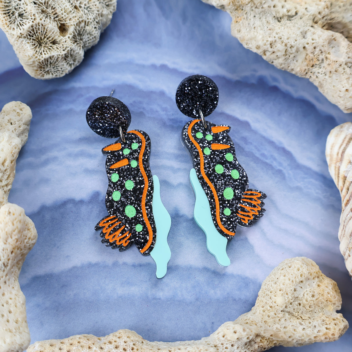 Laser cut acrylic nudibranch earrings,closeup.