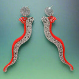 Pair of long statement sized oarfish acrylic earrings with red and silver bodies