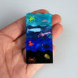 Ocean zones brooch in hand