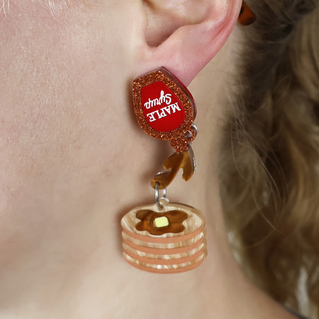 Acrylic pancake dangle earrings with a maple syrup earring topper, being modelled