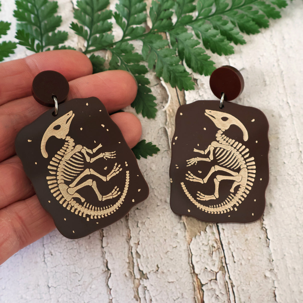 Brown acrylic earrings with etched Parasaurolophus skeletons