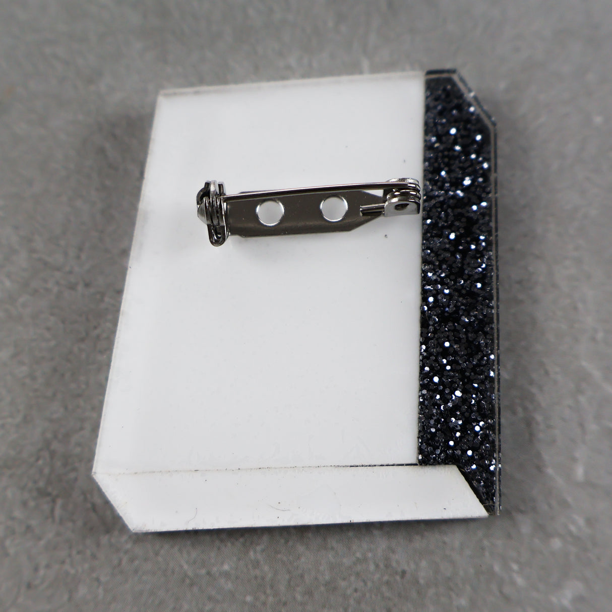 Book brooch back showing stainless steel brooch pin