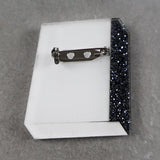 Book brooch back showing stainless steel brooch pin