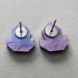 Back view of a pair of purple acrylic studs showing stainless steel posts