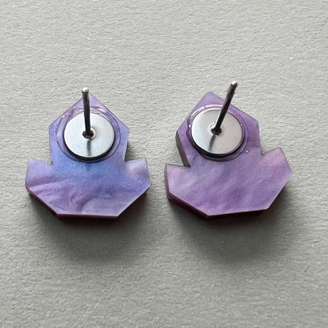 Back view of a pair of purple acrylic studs showing stainless steel posts