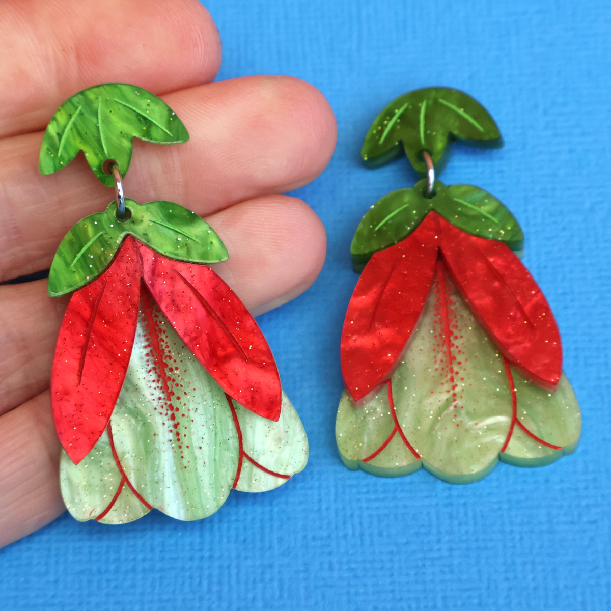 Qualop Bell Earrings in hand
