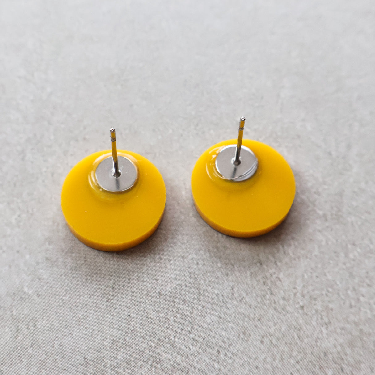 Back view of radioactive studs showing stainless steel earring posts. 