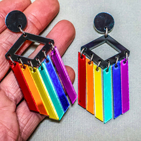 Rainbow mirror dangles in hand