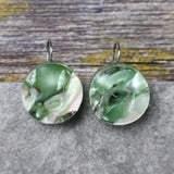 A pair of one of a kind round recycled acrylic earrings with stainless steel french hooks and green acrylics titled  'Green Ripple'. Pair 101-12