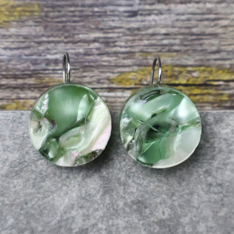 A pair of one of a kind round recycled acrylic earrings with stainless steel french hooks and green acrylics titled  'Green Ripple'. Pair 101-12
