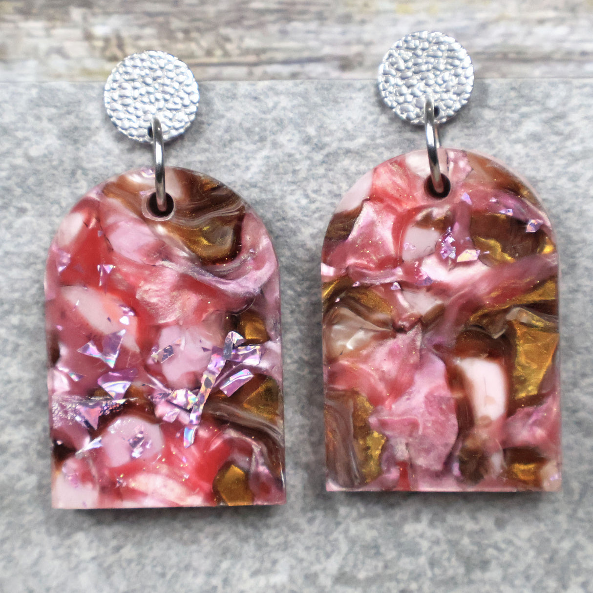A pair of one of a kind arch shaped recycled acrylic earrings with pink and brown acrylics titled  'Dusky Petals' and stainless steel toppers. Pair 101-07