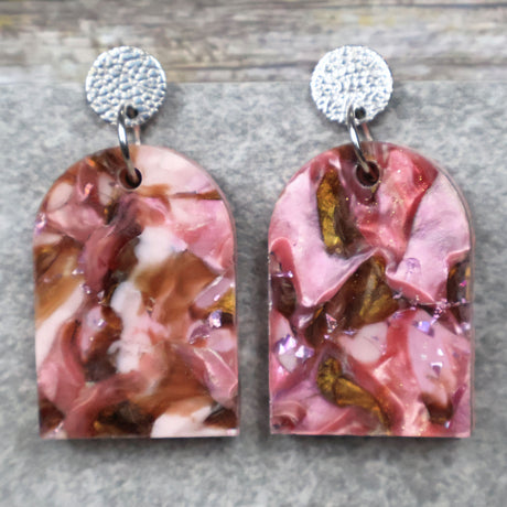 A pair of one of a kind arch shaped recycled acrylic earrings with pink and brown acrylics titled  'Dusky Petals' and stainless steel toppers. Pair 101-08