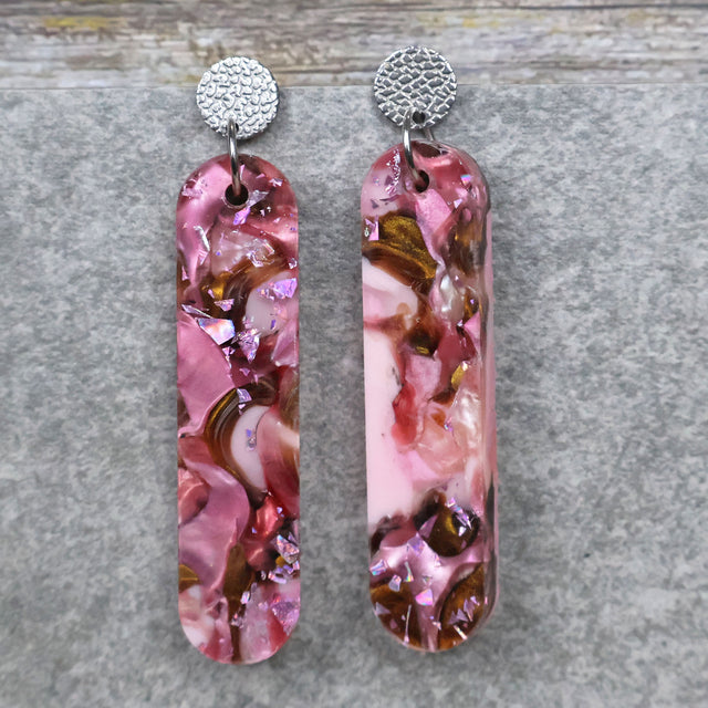 A pair of one of a kind long oval shaped recycled acrylic earrings with pink and brown acrylics titled  'Dusky Petals' and stainless steel toppers. Pair 101-09