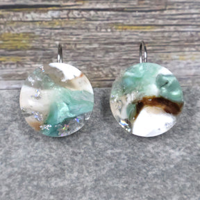 A pair of one of a kind round recycled acrylic earrings with stainless steel french hooks and silver, green and brown design titled 'Celestial Tide' Pair 106-17