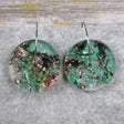 A pair of one of a kind disc shaped recycled acrylic earrings on stainless steel hoops with green and pink acrylics titled 'Enchanted Forest'. Pair 03-09
