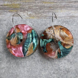 Pair of one of a kind disc acrylic earrings on stainless steel hoops with multicolored design titled 'Sunset Reef'. Pair 106-012