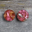 A pair of one of a kind round recycled acrylic earrings with stainless steel french hooks and multicolored design titled 'Sunset Reef'. Pair 106-14
