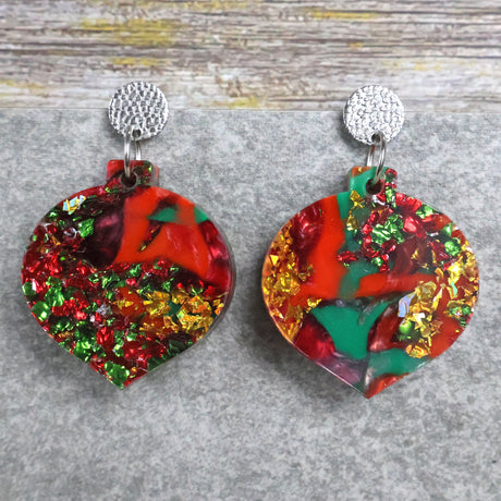 A pair of one of a kind recycled acrylic Christmas bauble earrings with stainless steel toppers, featuring a red, green and gold acrylic design. Pair 107-03
