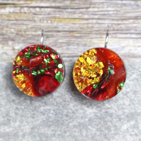 A pair of round recycled acrylic Christmas earrings with red, green, and gold colors, mounted on stainless steel french hooks. Pair 107-11