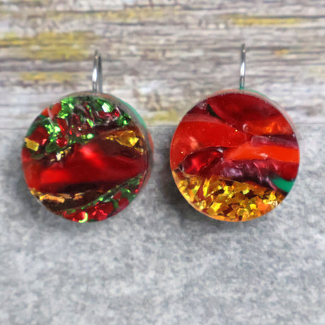 A pair of round recycled acrylic Christmas earrings with red, green, and gold colors, mounted on stainless steel french hooks. Pair 107-13