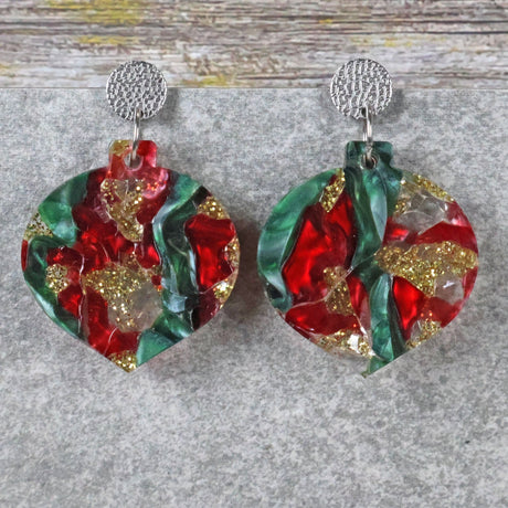 A pair of one of a kind recycled acrylic Christmas bauble earrings with stainless steel toppers, featuring a red, green and gold acrylic design. Pair 108-02