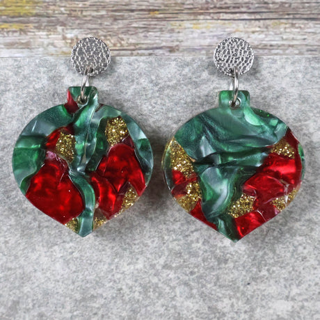 A pair of one of a kind recycled acrylic Christmas bauble earrings with stainless steel toppers, featuring a red, green and gold acrylic design. Pair 108-03