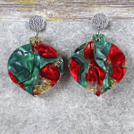 A pair of one of a kind recycled acrylic Christmas bauble earrings with stainless steel toppers, featuring a red, green and gold acrylic design. Pair 108-04