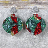 A pair of one of a kind recycled acrylic Christmas bauble earrings with stainless steel toppers, featuring a red, green and gold acrylic design. Pair 108-05