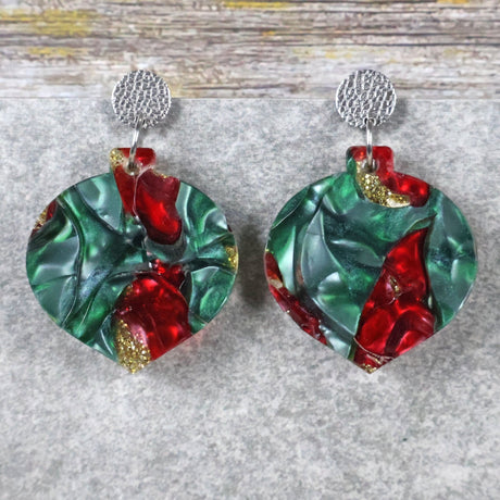 A pair of one of a kind recycled acrylic Christmas bauble earrings with stainless steel toppers, featuring a red, green and gold acrylic design. Pair 108-05