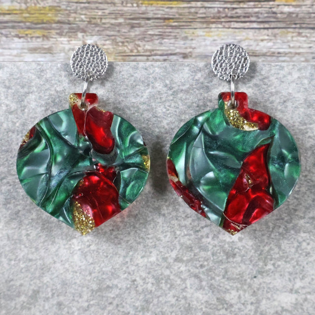 A pair of one of a kind recycled acrylic Christmas bauble earrings with stainless steel toppers, featuring a red, green and gold acrylic design. Pair 108-05