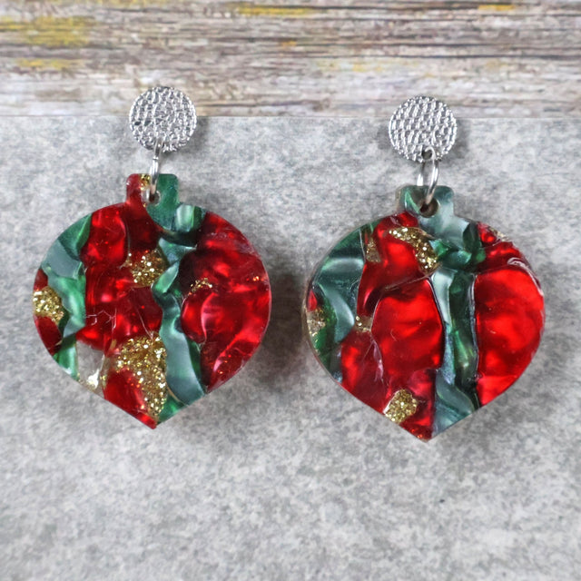 A pair of one of a kind recycled acrylic Christmas bauble earrings with stainless steel toppers, featuring a red, green and gold acrylic design. Pair 108-06