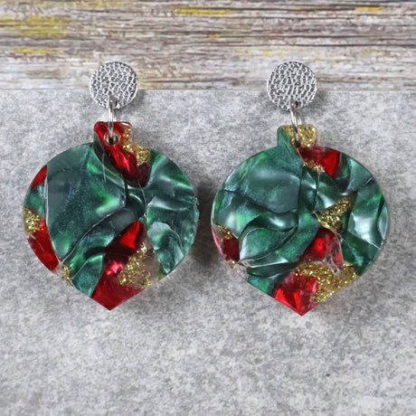 A pair of one of a kind recycled acrylic Christmas bauble earrings with stainless steel toppers, featuring a red, green and gold acrylic design. Pair 108-07