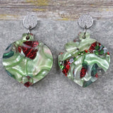 A pair of one of a kind recycled acrylic Christmas bauble earrings with stainless steel toppers, featuring a red and green acrylic design. Pair 109-03